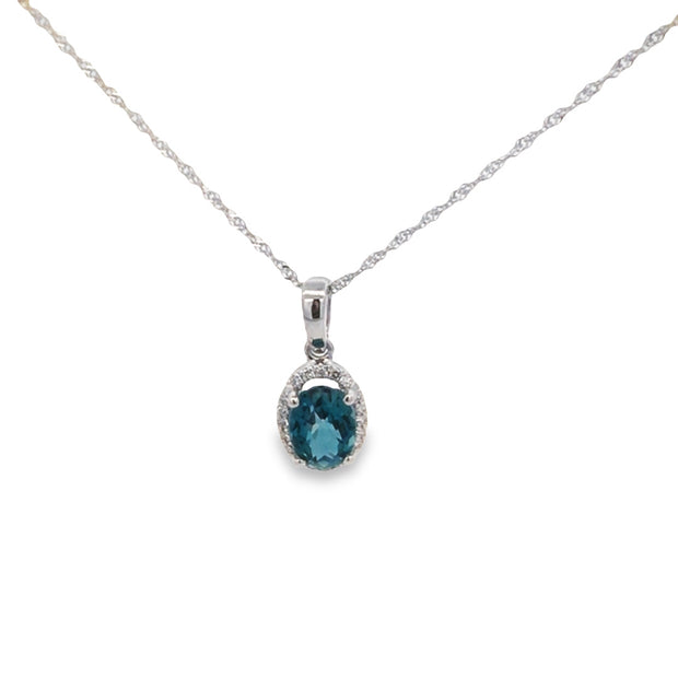 14kt White Gold Pendant With 6x8 Oval Blue Topaz 1.01ct Surrounded By