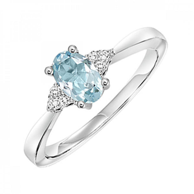 10kt White Gold Ring With Oval Blue Topaz and 6 Round Diamonds .06tdw
