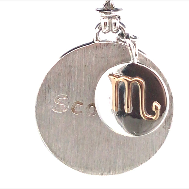 Sterling Silver Round Charm Scorpio Wih A Smaller Charm With An 18Kt Yellow Gold Zodiac Emblem
