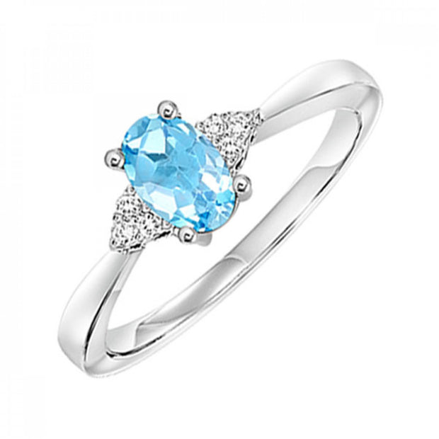 10kt White Gold Ring With Oval Blue Topaz and 6 Round Diamonds .06tdw