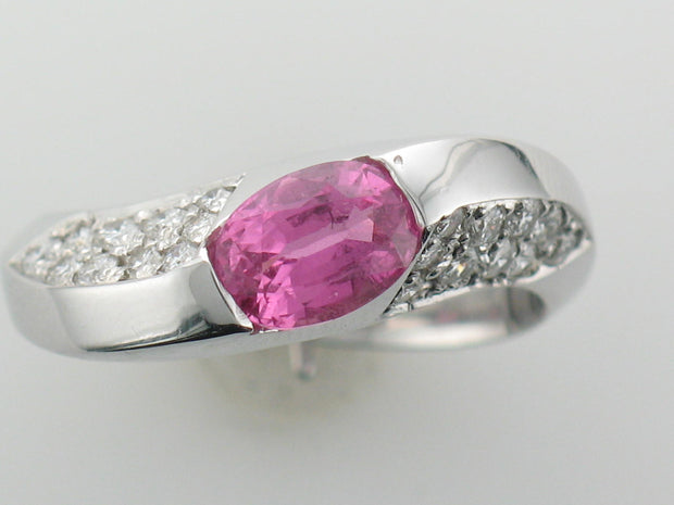 14Kt White Gold Ring With Oval Pink Sapphire In The Center And Pave Set Round Brilliant Diamonds On Either Side Of The Ring. .30Ct Tdw Si2 GH.