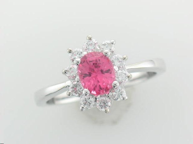 14Kt White Gold Ring With 10 Round Brilliant Diamonds .33Ct Tdw I1 HI Surrounding An Oval 6 X 5 Pink Spinel Stone.
