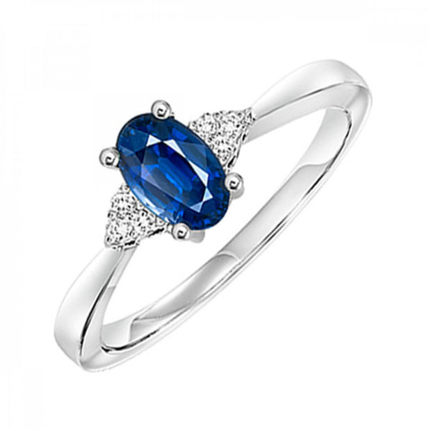 10kt White Gold Ring With Oval Blue Topaz and 6 Round Diamonds .06tdw