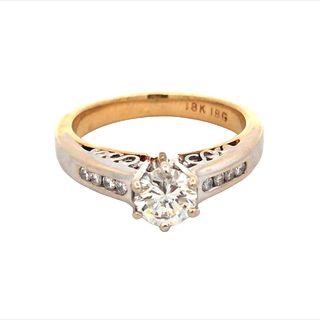 18Kt Two Tone Engagement Ring With 8 Channel Set Diamonds .16Ct Si2 I And One Round Center Stone .64Ct Si1 J.